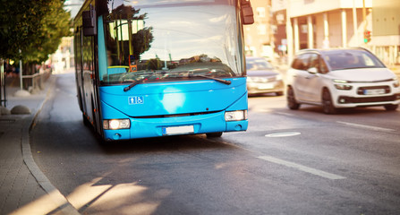 Bus moving on the road in city in early morning. View to the traffic with trafficlights and...