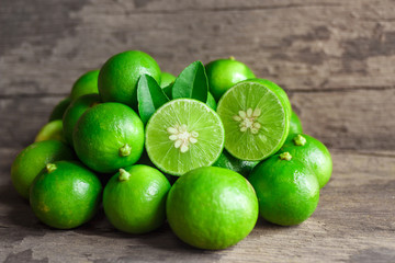 Limes on old wooden background