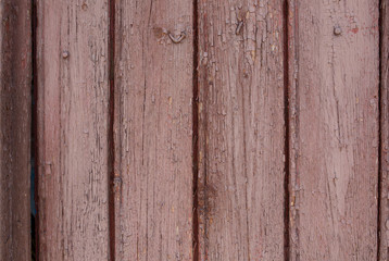 Old vertical pink wooden planks outdoors. Vintage rustic background texture.