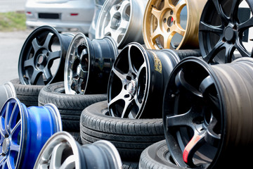Car sport rims and tyres shown at a tyre shop.