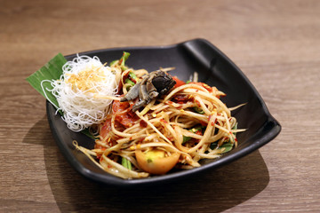 Papaya salad very hot and spicy food with black salt crab. Thai traditional yummy food.