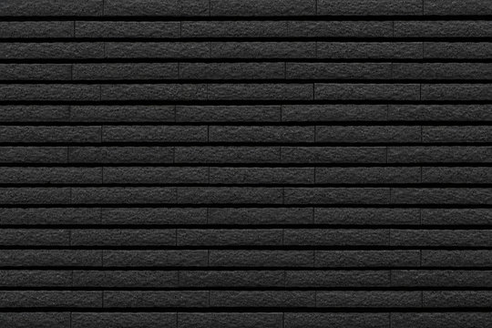 Black stone brick tile wall pattern and background