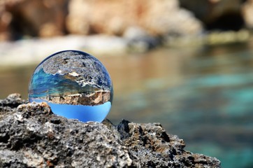 glass ball on stones close up