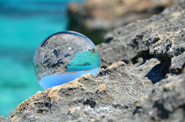 Fototapeta na wymiar crystal sphere on stones