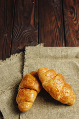 croissants on wooden table black background