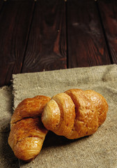 croissants on wooden table black background