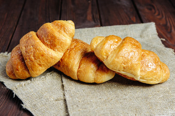 croissants on wooden table black background