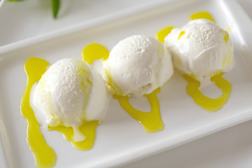 Bowl of  Vanilla ice cream isolated on white background. Vanilla Ice Cream with Mint in bowl and Mangoes sauce