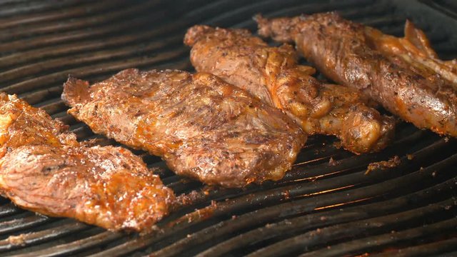 UHD shot of the delicious seasoned beef on the grill