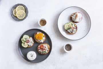 Toasts with mashed avocado and cucumber on white plate. Top view. Healthy eating, dieting, cleansing concept