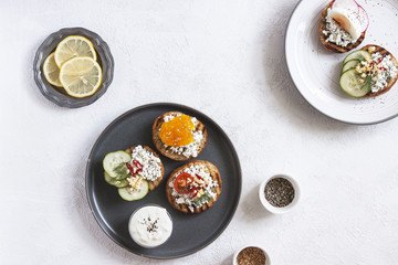 Toasts with mashed avocado and cucumber on white plate. Top view. Healthy eating, dieting, cleansing concept