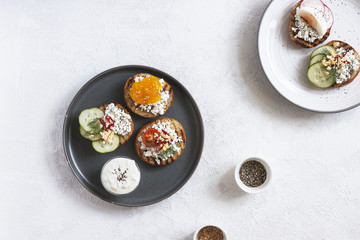 Toasts with mashed avocado and cucumber on white plate. Top view. Healthy eating, dieting, cleansing concept