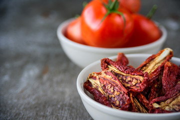 Bowls of fresh and dried tomatoes