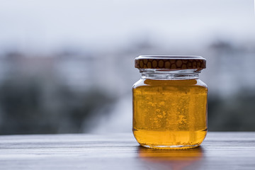 Honey in glass jar closeup,