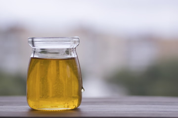Honey in glass jar closeup,