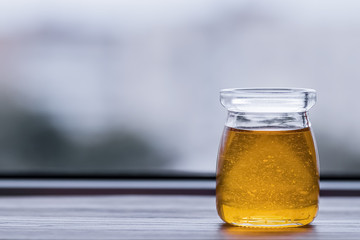 Honey in glass jar closeup,
