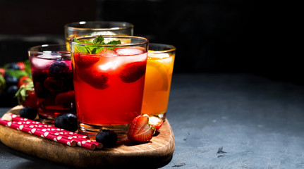 fruit and berry beverages with ice in assortment