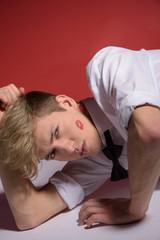 Sexy man in a classic white shirt with a bow tie