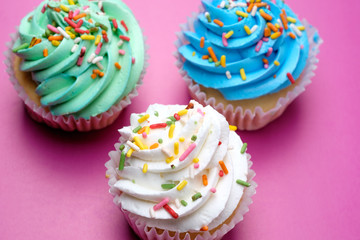 Tasty cupcakes on purple background, selective focus