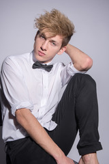 Obraz premium Fashion portrait of a man in a classic suit with a bow tie