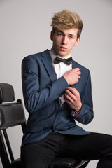 Young man posing in classic blue suit