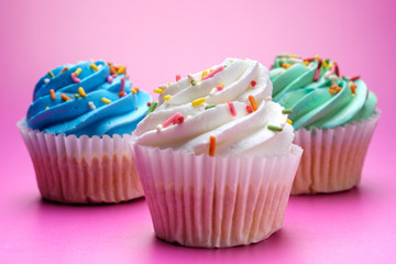 Tasty cupcakes on purple background, selective focus