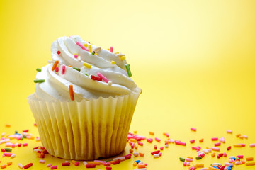 Tasty cupcakes on yellow background, selective focus