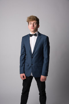 Young man posing in classic blue suit