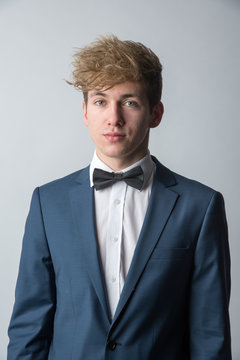 Young man posing in classic blue suit