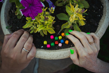 Hands of newlyweds on background wooden letters spelling just married.
