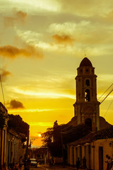 Cuban street sunset with oldtimer in Trinidad, Cuba