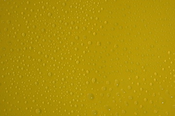 natural water drops on yellow background texture
