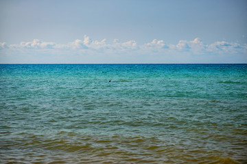 the blue ocean with dull clouds on a lovely sunny day