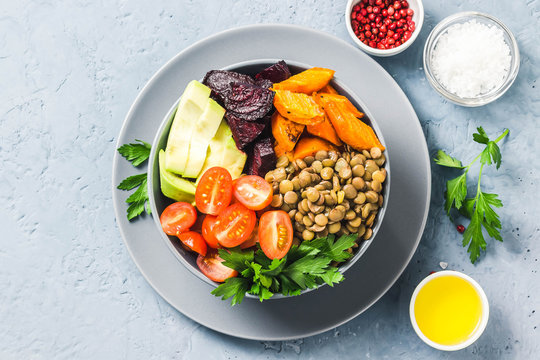 Buddha Bowl With Roasted Root Vegetables, Greens, Lentils, Tomatoes. Top View, Space For Text.