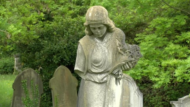 Cemetery in England: Angel holding flowers