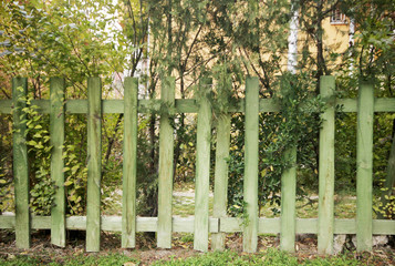 Wooden fence on green garden 