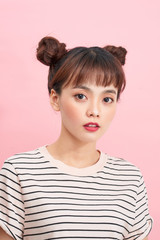 happy young woman against pink background