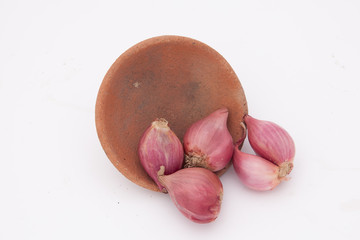 Shallots  and baked clay isolated on white background