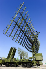 Air defense radars of military mobile antiaircraft systems in green color and ballistic rocket launcher with four cruise missiles, modern army industry 