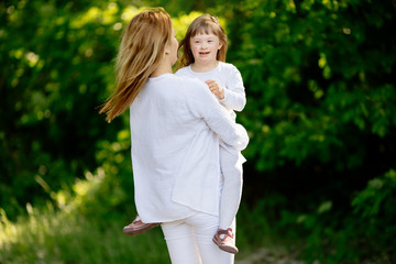 Baby with down sydrome enjoying outdoor play