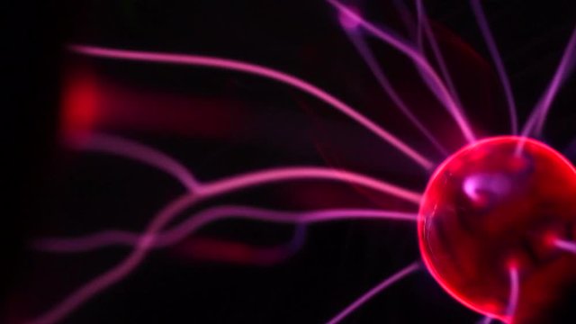 Plasma ball lamp, Tesla Coil experiment with electricity, plasma lamp closeup. Abstract backdrop. Slow motion 4K UHD video 3840X2160