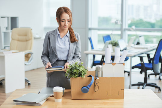 Businesswoman packing her stuff into the box at office