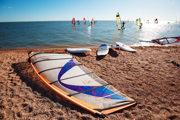 Windsurf boards on the sand at the beach. Windsurfing and active lifestyle