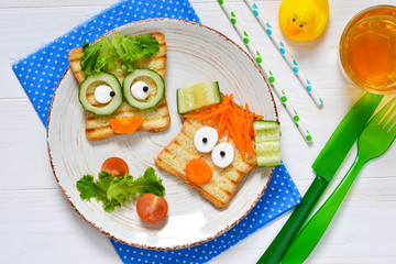 Breakfast for a child - children's funny toasts with a grilled and carrot.