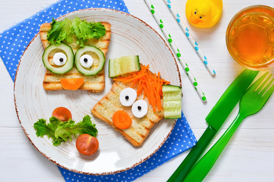 Breakfast for a child - children's funny toasts with a grilled and carrot.