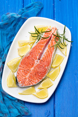 raw salmon with lemon on white dish