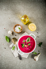 Vegan food, summer cold Beetroot gazpacho soup with lemon, avocado and fresh herbs copy space top view