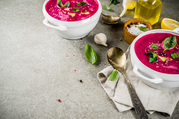 Vegan food, summer cold Beetroot gazpacho soup with lemon, avocado and fresh herbs copy space top view