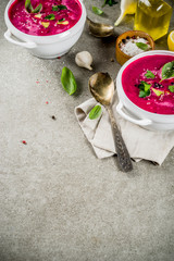 Vegan food, summer cold Beetroot gazpacho soup with lemon, avocado and fresh herbs copy space top view