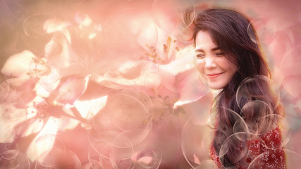 Obraz na płótnie Canvas soft dreamy look image of beautiful young asian woman show happy face with fresh feeling with pinky soft background of flowers and foreground of floating bubles